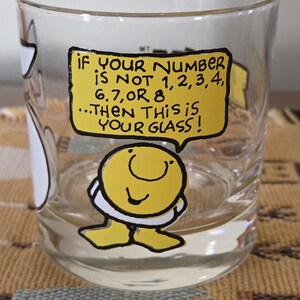 May include: Clear glass with a yellow speech bubble that reads "IF YOUR NUMBER IS NOT 1,2,3,4, 6,7,OR 8...THEN THIS IS YOUR GLASS!". A cartoon character is at the bottom of the glass.