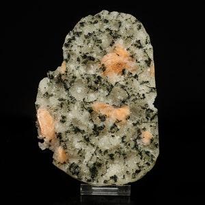 May include: A cluster of orange-colored crystals embedded in a matrix of white and green crystals. The crystals are arranged in a random pattern and have a smooth, polished surface.