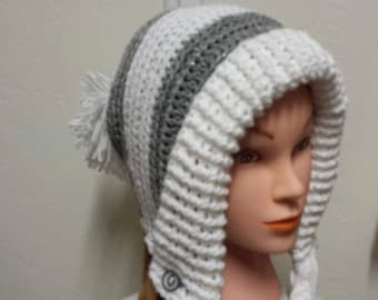 Slouchy, earflap hat with braids and pom pom.