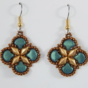 Può includere: Un paio di orecchini con un design oro e blu-verde. Gli orecchini sono fatti di piccole perline e hanno una forma a goccia.