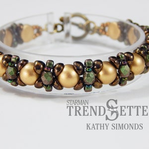 May include: A gold and green beaded bracelet with a clasp closure. The bracelet is made with small round beads and faceted beads. The beads are arranged in a repeating pattern.