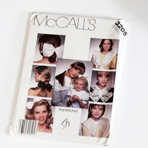 May include: McCall's sewing pattern number 3205 for a white lace collar. The pattern includes instructions for making different styles of collars, including a bow, a ruffle, and a simple collar.