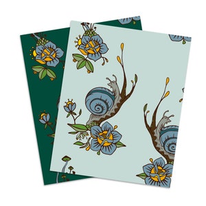 May include: Two sheets of wrapping paper with a blue and yellow floral pattern and snails on a blue background.