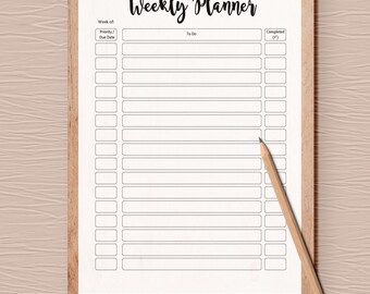 May include: A wooden clipboard with a white weekly planner sheet, held by a silver clip. The planner has sections for priority, due date, to-do items, and completion status. A wooden pencil rests on the planner.