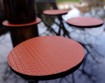 Set of 4 coasters made from a repurposed fire hose.