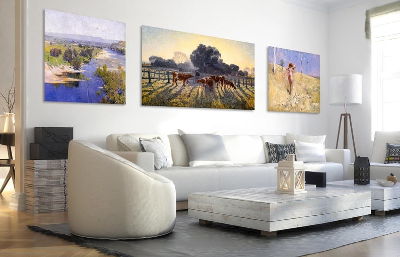 Puede incluir: Tres cuadros enmarcados colgados en una pared blanca en una sala de estar. Las pinturas representan una escena de r&iacute;o, un campo con ganado y una mujer de pie en un campo.