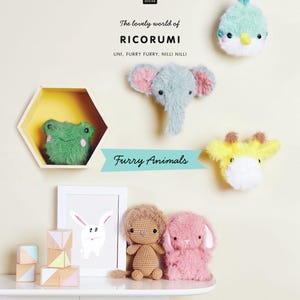 May include: A collection of handmade, furry animal toys, including a green frog, a blue elephant, a yellow giraffe, a brown lion, and a pink bunny. The image also features wooden blocks and a framed bunny drawing. Text includes "The lovely world of RICORUMI."