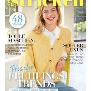 Könnte beinhalten: Magazin-Cover mit einer lächelnden Frau in einem gelben Cardigan über einem weißen Hemd. Der Magazintitel lautet "stricken". Text enthält "Frische Frühlings Trends" und "48 Modelle".