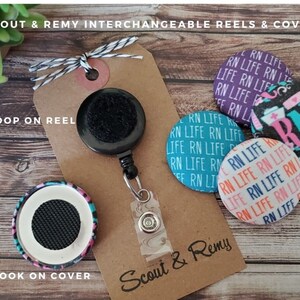 May include: A set of interchangeable badge reels and covers with a black retractable reel, a black and white striped lanyard, and three different patterned covers. The covers feature the text "RN Life" and a nurse's symbol. The text "Scout & Remy" is printed on the brown card.