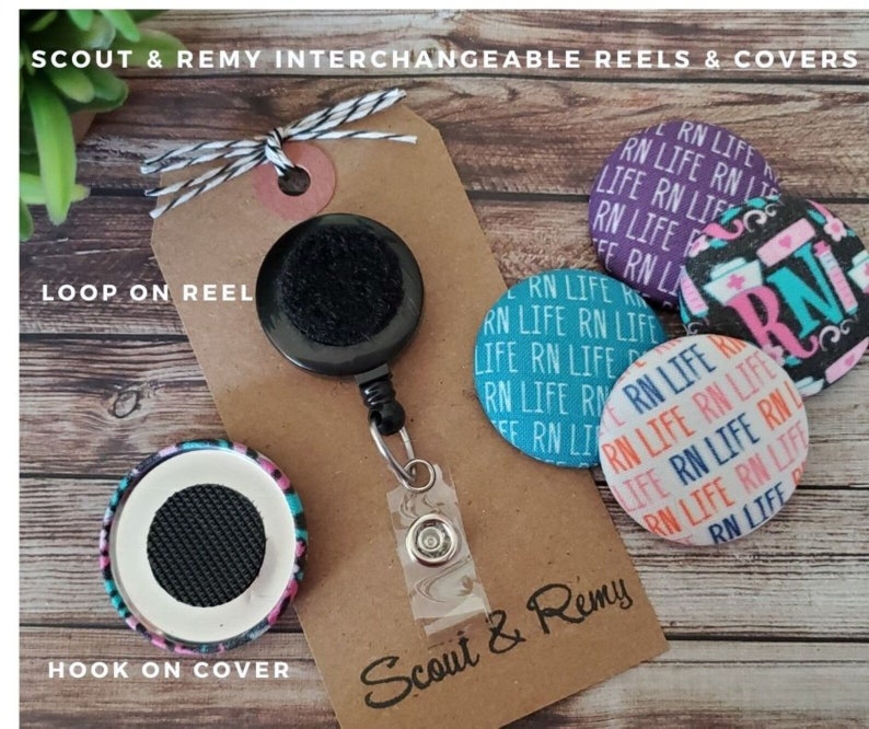 May include: A set of interchangeable badge reels and covers with a black retractable reel, a black and white striped lanyard, and three different patterned covers. The covers feature the text "RN Life" and a nurse's symbol. The text "Scout & Remy" is printed on the brown card.