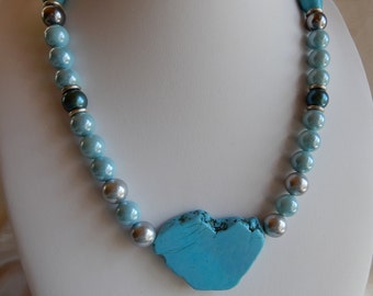 Turquoise necklace made of shell beads with a large howlite pendant. Unique gift from HillaBeads handmade in Gemany