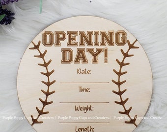 May include: A wooden baseball-shaped sign with the text "OPENING DAY!" and spaces to write the date, time, weight, and length. The sign is brown and has a white background.