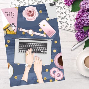 May include: A blue and gold planner with the text "DREAM. PLAN. DO." on the cover. The planner is open to a page with a laptop, a pink rose, a watch, a phone, and gold confetti.