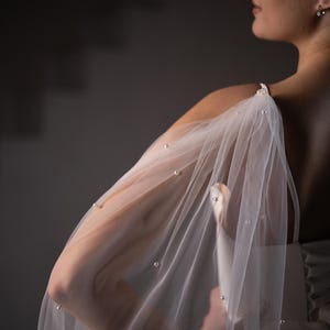 Modern bridal wings veil alternative in ivory tulle with optional pearls