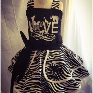 May include: A black and white zebra print dress with a black bodice featuring a white silhouette of Mickey Mouse with the word "LOVE" and animal silhouettes.