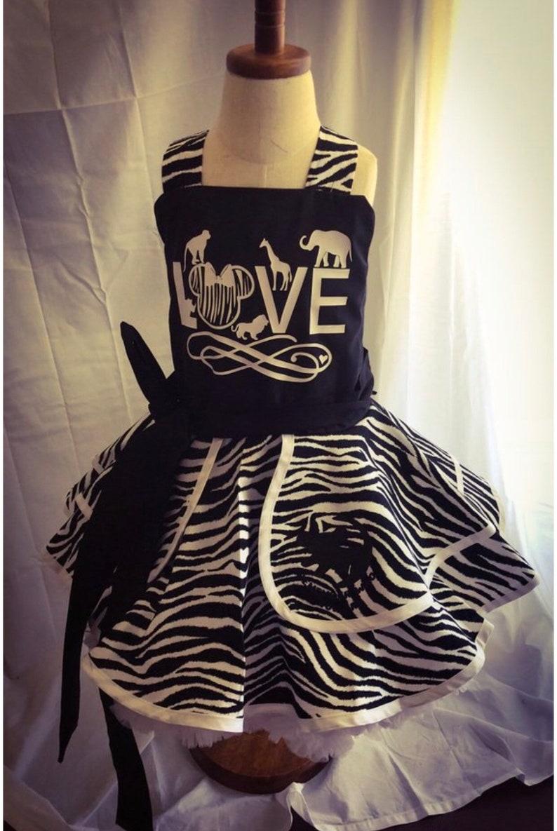 May include: A black and white zebra print dress with a black bodice featuring a white silhouette of Mickey Mouse with the word "LOVE" and animal silhouettes.