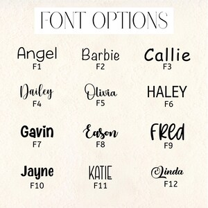 May include: A beige background displays the text "FONT OPTIONS" above a grid of name examples in various fonts. Names include Angel, Barbie, Callie, Dailey, Olivia, Haley, Gavin, Eason, Fred, Jayne, Katie, and Linda.
