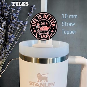 May include: White Stanley travel mug with a pink bear logo and a black and pink 10 mm straw topper that says "Life is better on a cruise".