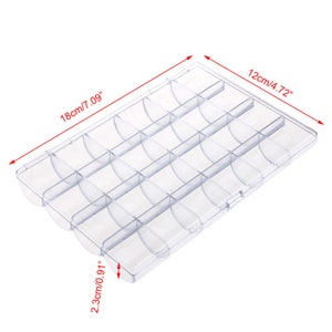 May include: Clear plastic storage box with 24 compartments. The box measures 7.09 inches long, 4.72 inches wide, and 0.91 inches high.