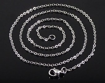 May include: A silver chain necklace with a lobster clasp closure. The chain is made of small, oval-shaped links.