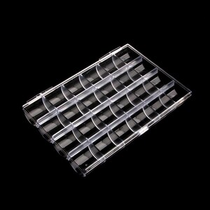 May include: A clear plastic storage box with 24 compartments. The compartments are curved and designed to hold small items.