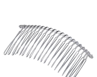 May include: Silver hair comb with a curved shape and multiple teeth. The comb is made of metal and has a shiny finish.
