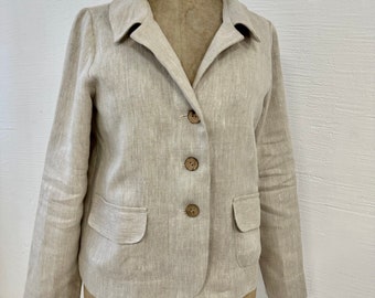 May include: A beige linen blazer with a notched collar, three buttons, and two pockets. The blazer is on a dress form.