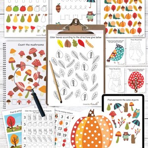 May include: A collection of autumn-themed educational activity sheets. The sheets feature patterns, tracing, counting, and matching exercises with illustrations of leaves, acorns, pumpkins, and mushrooms. A clipboard holds a coloring activity.