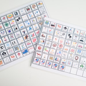 May include: Two white laminated sheets with colorful squares containing icons and text. The squares are arranged in a grid pattern. The icons represent various activities, holidays, and events. The text includes the names of the activities, holidays, and events.