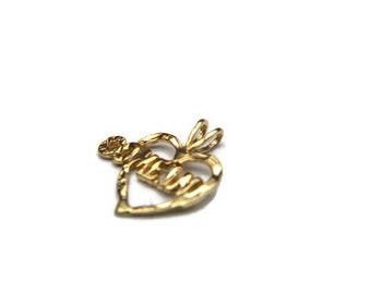 May include: Gold heart-shaped pendant with the word "Mommy" spelled out in a stylized font.