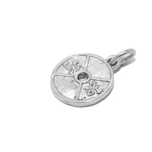 May include: Silver weight plate charm with a weight of 20 kg and 45 lbs. The charm has a circular shape with a hole in the center and is designed to look like a weight plate.