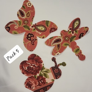 May include: A pack of five fabric appliques featuring a bee, a butterfly, and a dragonfly. The appliques are made of red and green patterned fabric.