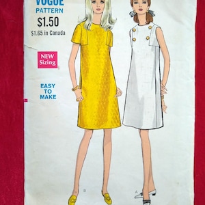 May include: A vintage sewing pattern for two dresses. The pattern is for sizes 12, 34, and 36. The pattern is for a yellow dress with short sleeves and a white sleeveless dress. The pattern is called "Vogue Pattern" and costs $1.50. The pattern is easy to make.