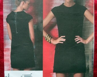 May include: A black dress with a zipper down the back and a short sleeve. The dress is shown on a model with a red background. The text "V1150", "PATTERN/PATRON", "SIZE/TAILLE", "BB", "(8-10-12-14)", "V1150/BB", "1", "031664 43192 3", "VOGUE PATTERNS AMERICAN DESIGNER", "CYNTHIA STEFFE" is printed on the bottom of the image.