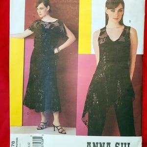 May include: Vogue American Designer Anna Sui pattern V2778. The pattern features two black evening wear designs. One is a dress with a sheer overlay, and the other is a top with pants. The pattern sizes are 8, 10, and 12.