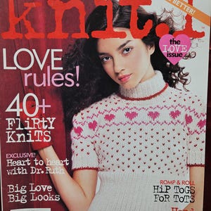 May include: Vogue Knitting Presents knit.1 Winter 2006/07 magazine cover featuring a short-sleeved white sweater with a red and pink heart pattern. The text includes 'LOVE rules!', '40+ Flirty Knits', 'the LOVE issue', and 'Heart to heart with Dr. Ruth'.