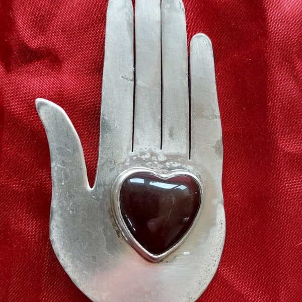 Lovely sterling and garnet hand brooch by Great Falls Metal Works