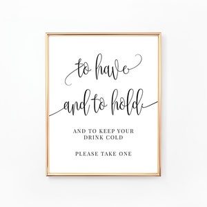 Puede incluir: Un cartel con marco dorado con el texto "to have and to hold" en letra cursiva. Debajo del texto, se lee "And to keep your drink cold. Please take one."