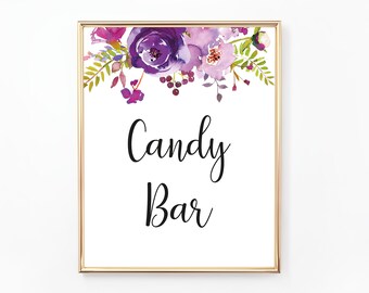 May include: A framed sign with a gold border, featuring the words "Candy Bar" in elegant script. The top of the sign is adorned with watercolor floral art in shades of purple, pink, and green, creating a decorative and inviting design.