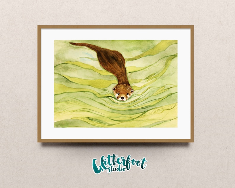 May include: Watercolor painting of a brown otter swimming in green water. The otter is depicted diving downwards, with its head and front paws visible above the water's surface. The artwork is framed in a light brown wooden frame.