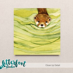 May include: Watercolor illustration of an otter emerging from green and yellow water. The otter has brown fur and a white face. The image has the text "Glitterfoot Studio" and "Close Up Detail".