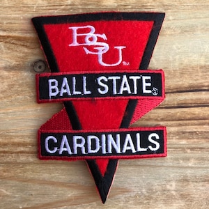May include: A red and black felt patch with a white embroidered triangle containing the letters "BSU" and the text "BALL STATE CARDINALS".