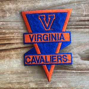 May include: A blue and orange embroidered patch with the text "VIRGINIA CAVALIERS" and a large "V" in the center.