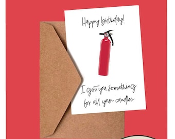 May include: A white card with the text "Happy birthday!" and a red fire extinguisher. Below the fire extinguisher is the text "I got you something for all your candles". The card is in a brown envelope. The card is on a red background with a white circle with a green leaf and the text "aspen hill craftery".