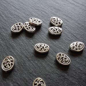 10 or 50 Flattened Oval Beads Antique Silver Tone 12x10mm 3.5mm Wide