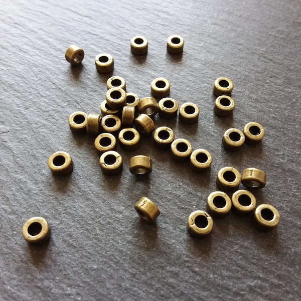 20 ou 100 perles d’espacement unies de ton bronze antique de 6 mm 6x3 mm. Trou de 2,8 mm