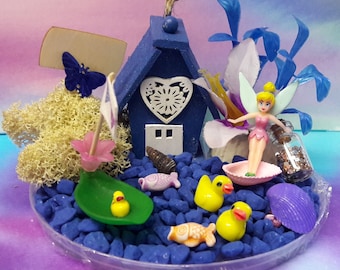 Fairy Water Garden Set. Fairy or Pixie house and garden with flowers, boat, creatures, moss, stones, in clear saucer.