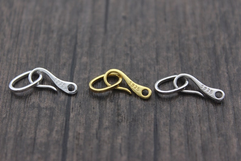 May include: Three silver-toned metal clasps with a hook design. Each clasp has the text "S925" engraved on it.