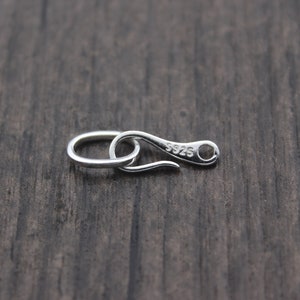 May include: Silver-toned metal clasp with a hook and loop closure. The clasp is marked with the number "925" indicating it is made of sterling silver.