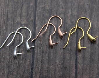 May include: Three pairs of earring hooks in silver, rose gold, and gold. The hooks are all the same shape, with a small loop at the top and a teardrop-shaped end.